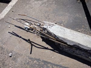 Broken_concrete_parking_chock_with_exposed_rebar